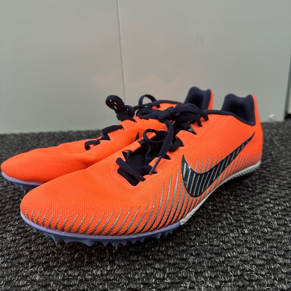Nike Zoom Rival M 9 track and field spikes in a bright orange and blackened blue